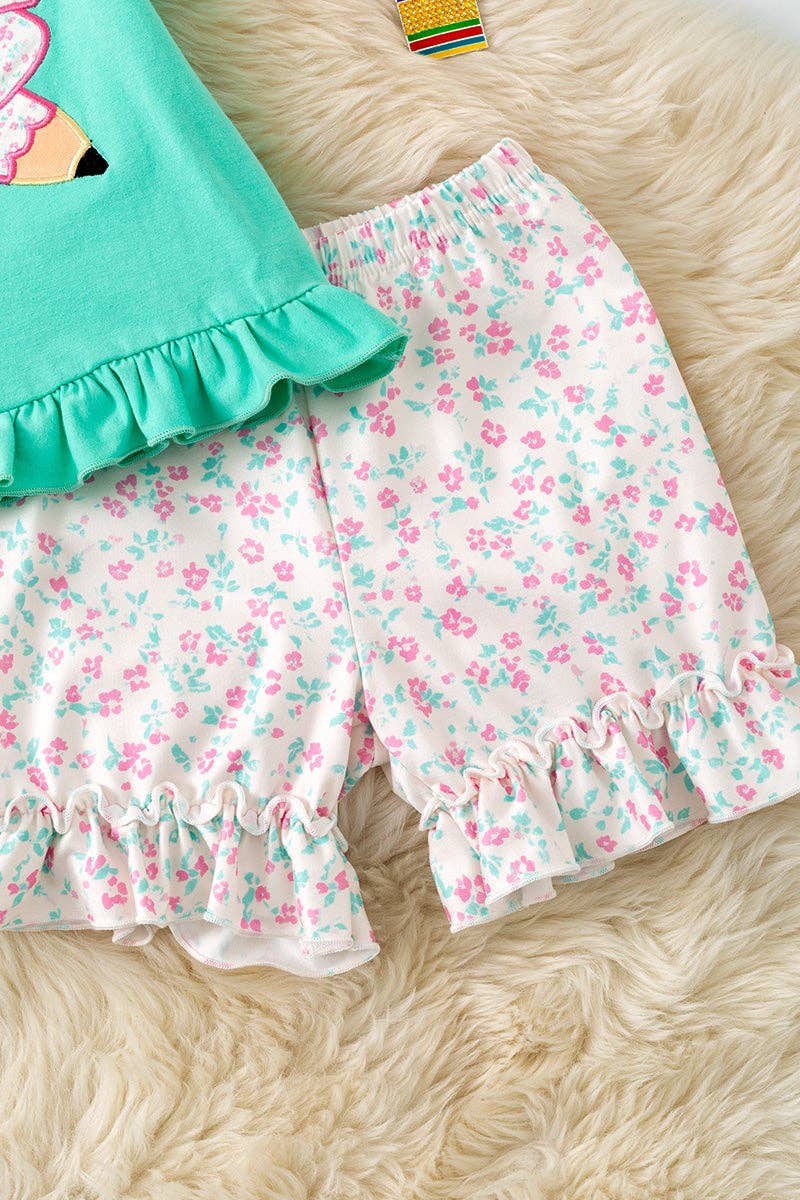 Pencil applique on mint top and floral shorts.  OFG60551